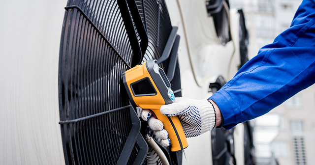 hvac tech uses thermal gun