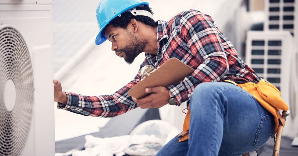 HVAC technician working on a roof
