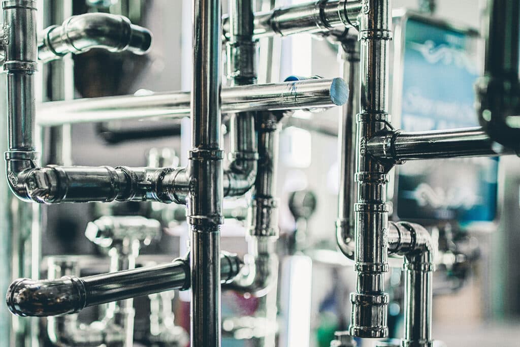 A detailed network of plumbing pipes, illustrating the systems involved in how to become a plumber.