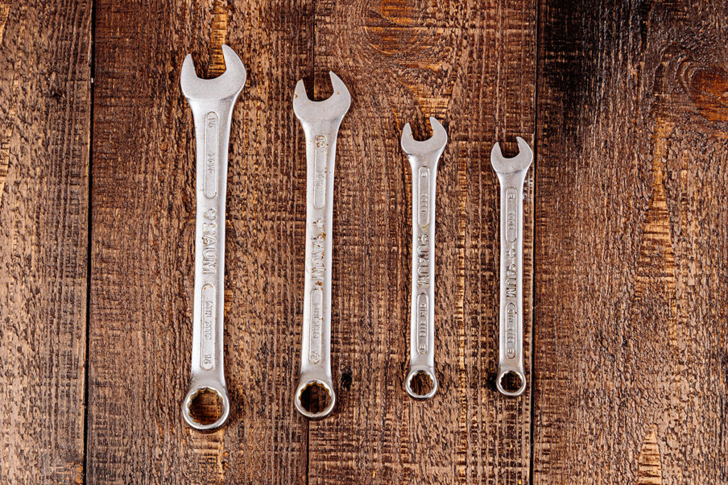 Various wrenches used by plumbers, highlighting essential tools that impact plumber salary and job success.